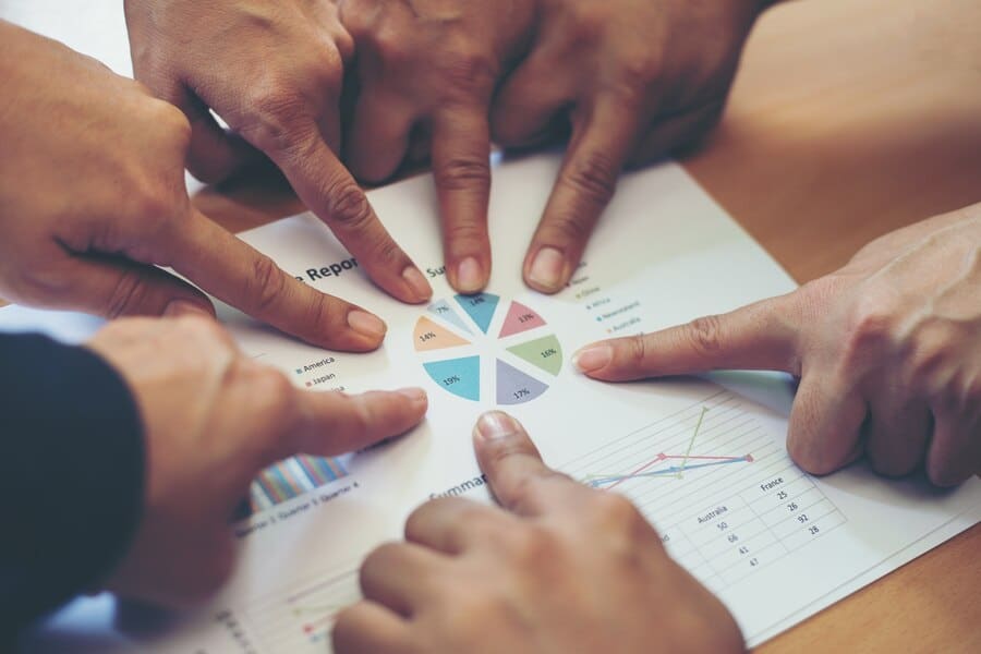 A group of Diverse Professionals Looking at Statistics