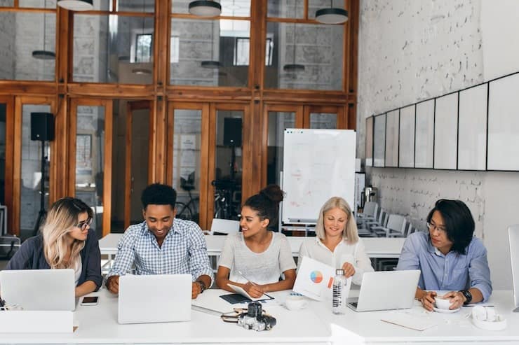 8 Inclusive Hiring Practices To Adopt in 2025 2 Recruiters in a strategy meeting