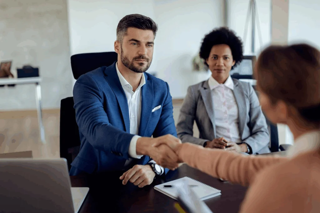 A man handshaking a woman